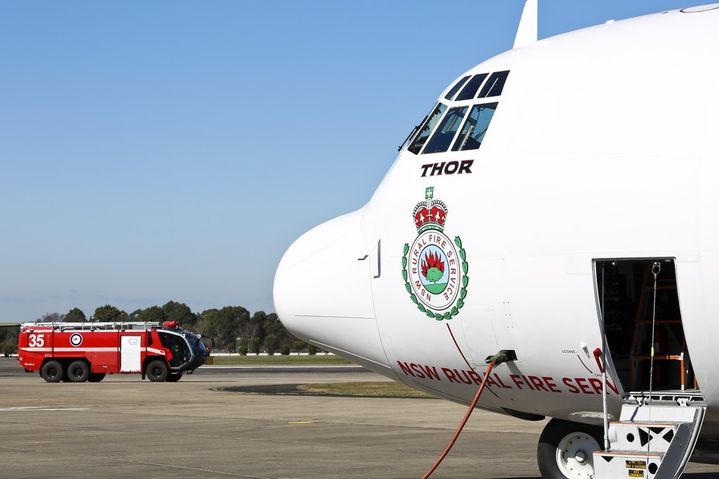 'Thor', a C-130 Hercules contracted to the NSW Government to assist in fighting bushfires, on the hard stand at RAAF Base Richmond. *** Local Caption *** RAAF Base Richmond will be used to provide airfield support services to Large Air Tanker and Very Large Air Tanker aircraft contracted to the New South Wales (NSW) Government from 01 September 2015 to 20 January 2015, assisting with NSW Rural Fire Service (RFS) efforts to combat bushfires. Defence is providing a number of services including aircraft parking and security, access to fuel and refuelling facilities, equipment storage, use of resources including water, aircrew office space, and meals and accommodation for up to 20 people, as required. Facilitating the aircraft at RAAF Base Richmond is intended to maximise aircraft utility and provide access to all areas of NSW in the event of a bushfire emergency. State and Territory Governments have primary responsibility for the protection of life, property and the environment, and for coordinating and planning an emergency response or recovery within their jurisdictions. Ground-based and aerial bush fire fighting is a highly specialised field that requires equipment and training that, in general, Defence does not possess. RAAF Base Richmond will be used to provide airfield support services to Large Air Tanker and Very Large Air Tanker aircraft contracted to the New South Wales (NSW) Government from 01 September 2015 to 20 January 2016, assisting with NSW Rural Fire Service (RFS) efforts to combat bushfires. Defence is providing a number of services including aircraft parking and security, access to fuel and refuelling facilities, equipment storage, use of resources including water, aircrew office space, and meals and accommodation for up to 20 people, as required. Facilitating the aircraft at RAAF Base Richmond is intended to maximise aircraft utility and provide access to all areas of NSW in the event of a bushfire emergency.