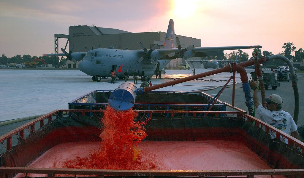 CHANNEL ISLANDS AIR NATIONAL GUARD STATION, Calif. -- - A Modular Airborne Fire Fighting System equipped C-130E Hercules from the 146th Airlift Wing here is reloaded with Phoschek fire retardant to be dropped on the Simi Fire in Southern California on Oct. 28. Pilots flying eight Air Force C-130 Hercules cargo airplanes have dropped 129,600 gallons of retardant on the Simi fire during 48 sorties and 32 flying hours as of Oct. 29. (U.S. Air Force photo by Senior Master Sgt. Dennis W. Goff)